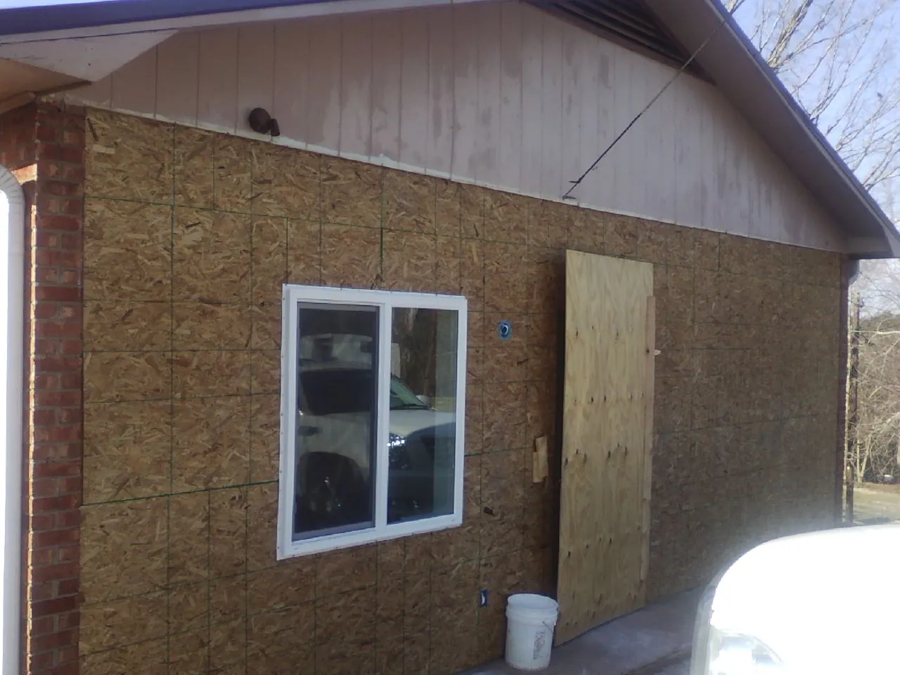 OSB sheathing on a garage addition wall before siding in Chippewa Lake